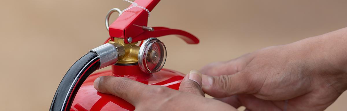 Hands on a Fire Extinguisher