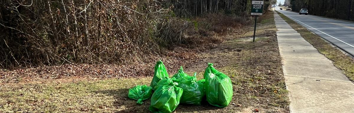 bags of collected litter along Wesmark Blvd