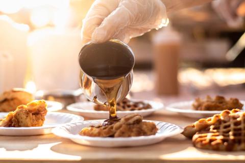 Syrup Being Poured Over Chicken & Waffles