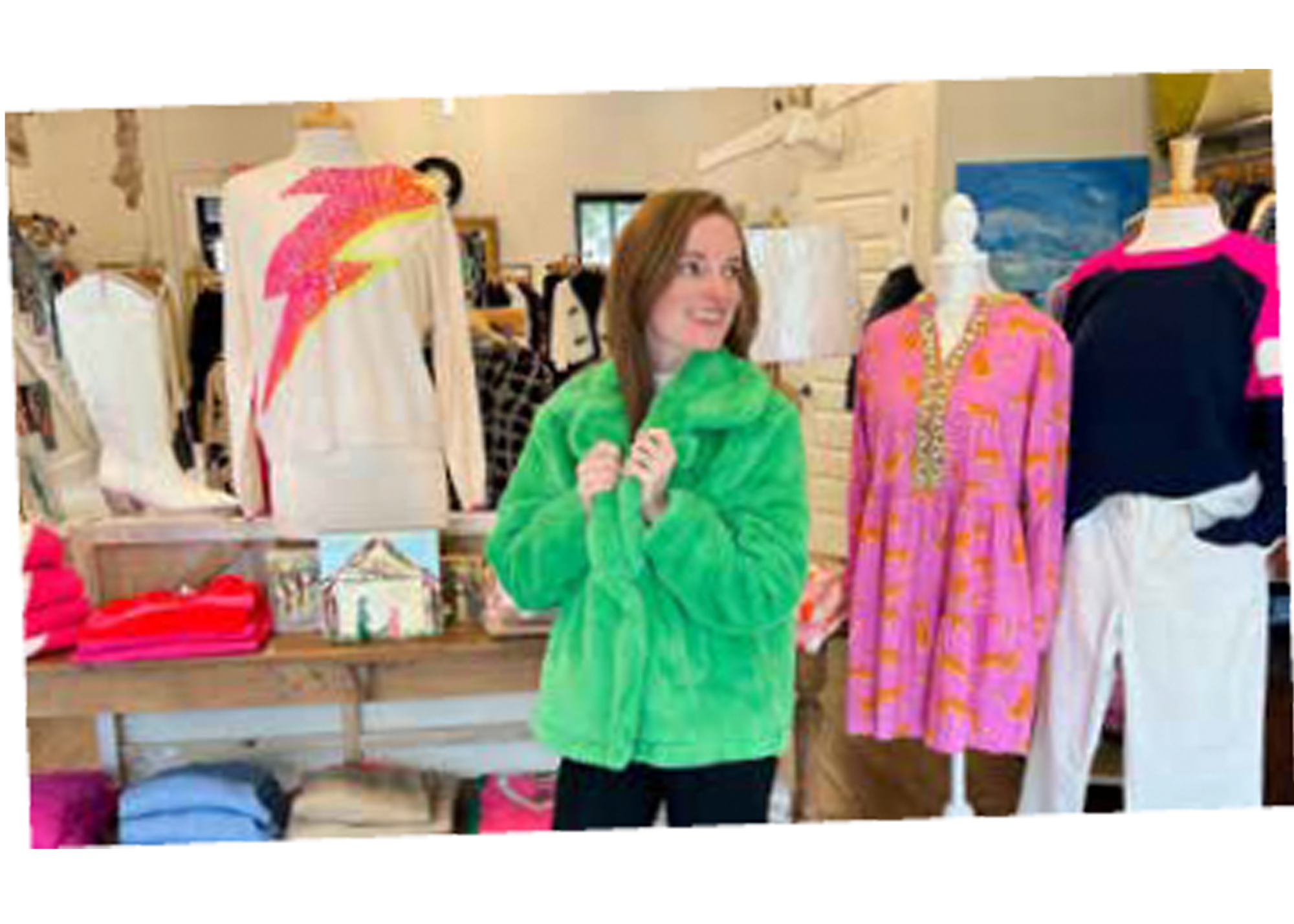 Young woman trying on clothes in front of clothing displays at One Accord in Sumter, SC