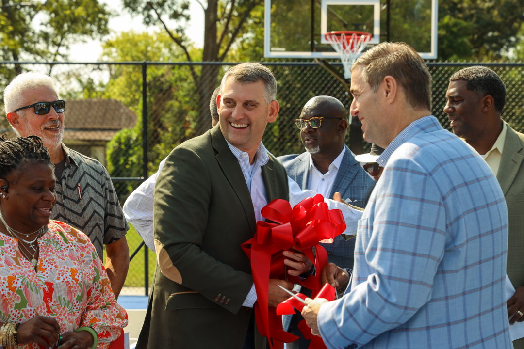 Mayor David Merchant and Speaker of the House Murrell Smith speak with local community members